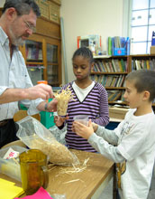 Photo of Bob Imber with his fourth-grade students working on designing solar ovens.