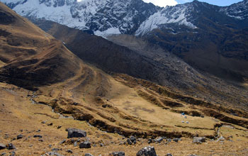 Photo of moraine ridges in a valley; base camp tents are visible in the lower right.