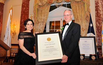 Photo of NSB's France Córdova presenting the 2011 Vannevar Bush Award to Charles Vest.