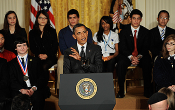 President Obama with a group of young people seated behind him