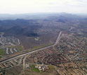 Photo of an aerial view of land, buildings and roads.