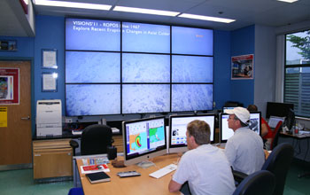 Photo of oceanographers watching the live video feed onshore at Rutgers University.