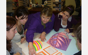 Photo of teacher Diane Schnellhammer working with students on a math project.