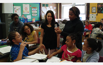 Photo of teacher Darcy Hampton leading her 8th-grade physical science class in a discussion.