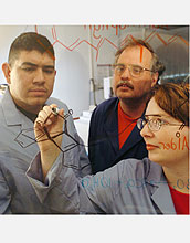 PECASE recipient Eugene Billiot and two students work on molecular structures.