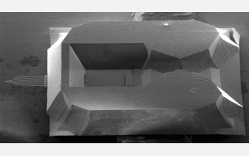 The scanning electron micrograph shows a nanofountain-probe chip, including the on-chip reservoir