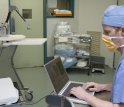 Michael Brady of Robotic Surgical Tech tests the Penelope SIS robotic arm prior to surgery.