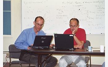 Atlas of Lie Groups Project members Fokko du Cloux (left) and Jeffrey Adams discuss E8.