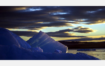 Photo of sea-ice and a cloudy sky.