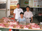 Photo of David Ortega and Dr. Laping Wu with a pork seller in Shijiazhuang, Hebei Province, China.