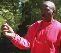 Photo of a Cedar Creek inmate and researcher in the Moss-in-Prisons project holding moss.