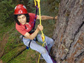 Photo of Nalini Nadkarni scaling an old-growth Douglas-fir tree in the Cascade Mountains.