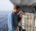 marine chemist Ken Buesseler making a final inspection of a water-sampling rosette.