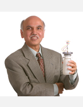 Photo of G.K. Surya Prakash holding a liquid-methanol fuel cell.
