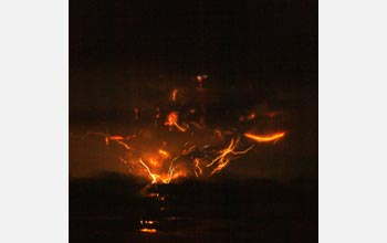 Photo of lightning in the clouds around a volcanic plume.