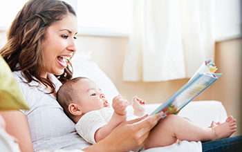 Woman reading to a baby on her lap