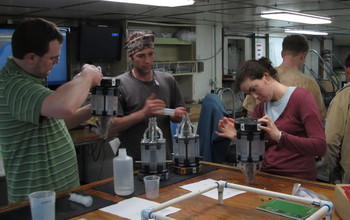 Aboard ship, scientists process samples of Zetaproteobacteria