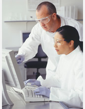 Photo of scientists collaborating at a computer.