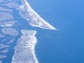 An aerial view of Long Island shows its low-lying shores, vulnerable to sea-level rise effects.
