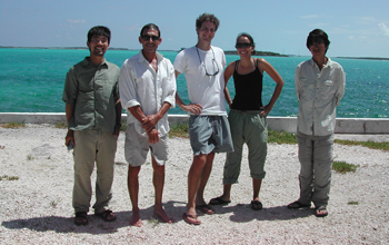 Photo of David Spiller, second from left, and other scientists posing on a beach in the Bahamas.