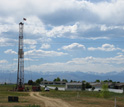 Photo of a workover rig completing a well near a surburban development in Weld County, Colo.