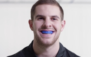 smiling face showing off mouth guard