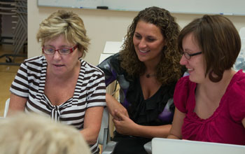 Photo of graduate research assistant Charity Cayton in center with teachers at workshop.