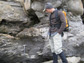 Photo of Geologist Noah Plavansky examining rocks deposited after a Snowball Earth glacial event.