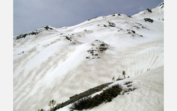 Photo showing zebra stripes of dust and snow on the snow surface in Colorado mountains.