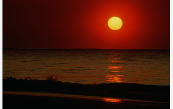 Image of the sun on the ocean's horizon.
