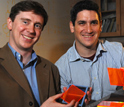 Photo of Marc Baldo and Shalom Goffri of MIT holding examples of organic solar concentrators.