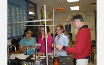 Photo of teacher and students in chemistry lab.