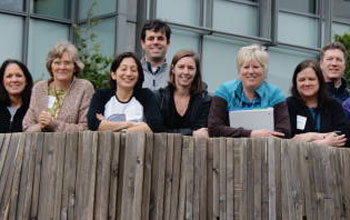 group of teachers posing outside a building