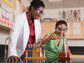 Photo of a teacher and student in a science lab.