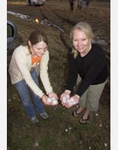 Photo of two students holding hailstones.