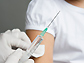 Photo of a health care professional administering a vaccine.