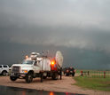 Doppler-on-Wheels and cars with a tornado in the background