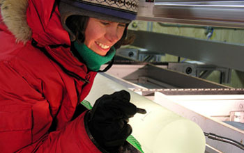 A scientist examines an ice core in West Antarctica