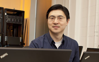 Mung Chiang in his office surrounded by computers.