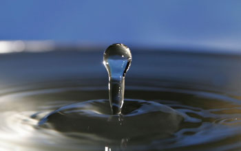Photo of a drop reaching water.
