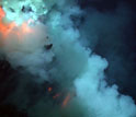 Photo of an eruptive blast at West Mata Volcano, with superheated pillow lava flowing downslope.