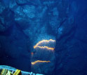 Photo showing a pillow lava tube extending downslope in an area about three feet across.