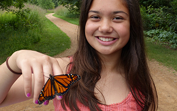 a girl with a butterfly on her hand