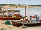 photo of fishing boats lining the beach