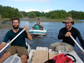 three people in boats