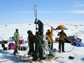 scientists in Antaractica drilling a borehole