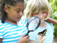 two girls observing a butterfly