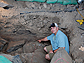 News thumbnail of researcher and cave interior