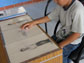 a child at a desk looking at drawings