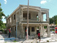 researcher surveys a damaged residence in Haiti